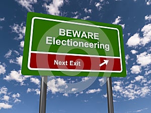 beware electioneering next exit traffic sign on blue sky