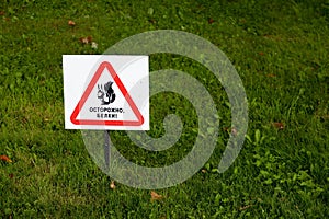 Beware of squirrel sign on grass close up