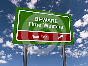 beware time wasters next exit traffic sign on blue sky