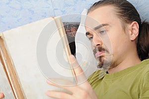 Bewildered man reading book