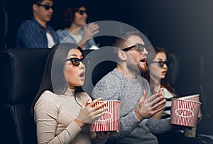 Bewildered people scared of 3D thriller in movie theater