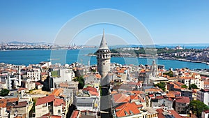 Beyoglu Region and Galata tower, one of the ancient symbols of Istanbul. Crowded city skyline and Bosphorus in the background