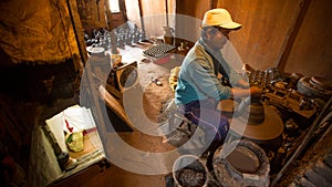 BHAKTAPUR, NEPAL - Nepalese man working in the his pottery workshop.