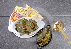 Bhindi Masala or stuffed Bhindi or okra, an Indian vegetable  on a plate with copy space