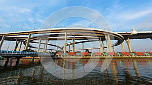 Bhumibol Bridge with skyline reflection against blue sky in Bangkok