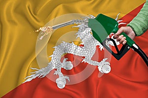 BHUTAN flag Close-up shot on waving background texture with Fuel pump nozzle in hand. The concept of design solutions. 3d