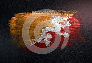 Bhutan Flag Made of Metallic Brush Paint on Grunge Dark Wall