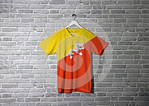 Bhutan flag on shirt and hanging on the wall with brick pattern wallpaper