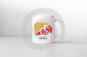 Bhutan flag on white coffee mug.