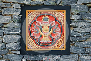 Bhutan style woodcraft on the rock wall photo