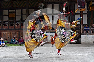 Bhutanese Sha Na Cham , black hat dance . dancers leap into the air .Bumthang, central Bhutan.