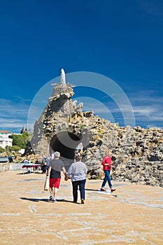 Biarritz, France - May 20, 2017: tourists visiting famous rocher de la vierge on atlantic coastline in basque country in sunny blu