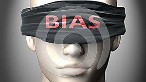 Bias can make things harder to see or makes us blind to the reality - pictured as word Bias on a blindfold to symbolize denial and photo