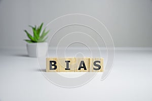Bias - word from wooden blocks with letters, personal opinions prejudice bias concept, white background