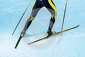 Biathlete or cross-country skier back with legs and equipment detail of legs