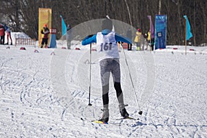 Biathlete skier coming down the slope during the competition .