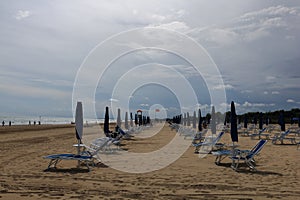 Bibione beach Italy with clear blue sky and sun umbrellas