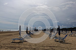 Bibione beach Italy with clear blue sky and sun umbrellas photo