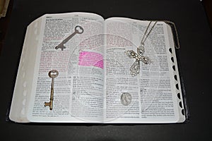 Bible with cross, keys and gardian angle photo