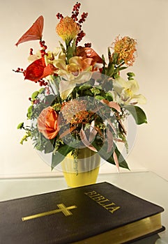 Bible and flowers on table