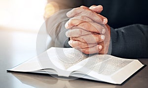 Bible, hands and prayer of a man reading christian text for spiritual healing and religion. Lens flare, hand closeup and