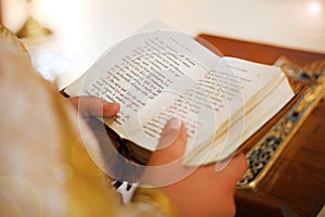 The Bible is in the hands of a priest, a holy father