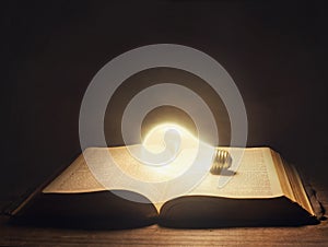 Bible with light bulb