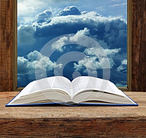 Bible open book wooden window sky view