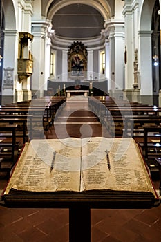 A bible open on a lectern at the entrance of a Catholic church in Urbino, central Italy photo