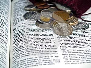 Bible opened to the Book of Proverbs with Coins