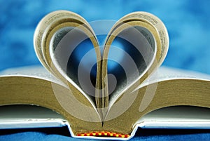 Bible pages curled as a heart