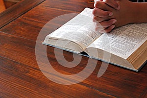 Bible and  pray  hands together background with copy space  table