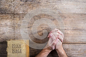 Bible and praying hands