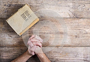 Bible and praying hands