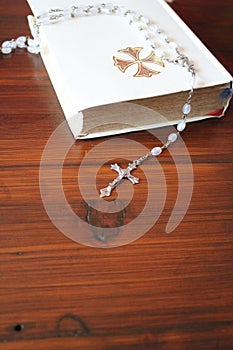 Bible and rosary beads for a catholic to pray  background with copy space