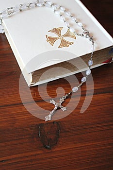 Bible and rosary beads for a catholic to pray  background with copy space