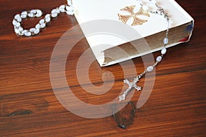 Bible and rosary beads for a catholic to pray  background with copy space