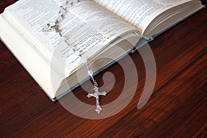 Bible and rosary beads for a catholic to pray  background with copy space