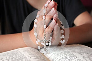 Bible and rosary beads for a catholic to pray  background with copy space