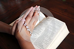 Bible and rosary beads for a catholic to pray  background with copy space