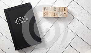 Bible Study in Block Letters on White Wooden Table with a Bible