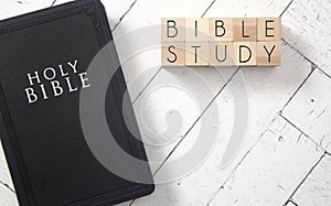 Bible Study in Block Letters on White Wooden Table with a Bible