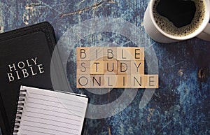 Bible Study Online Written in Block Letters on a Blue Wood Table with a Bible