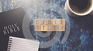 Bible Study Written in Block Letters on a Blue Wood Table with a Bible