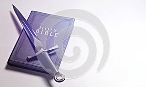Bible and Sword on a Bright White Background