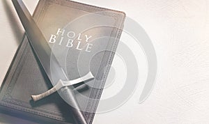 Bible and Sword on a Bright White Background