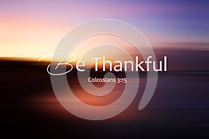 Bible verse inspirational quote - Be thankful. Colossians 3:15 On colorful abstract background illustration of blur sunrise sky photo