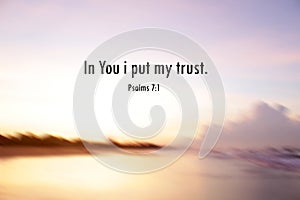 Bible verse inspirational quote - In You i put my trust. Psalms 7:1 On blur background of bright warm sunset view over the sea.