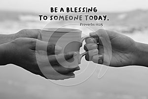 Bible verse quote - Be a blessing to someone today. Proverbs 11:25. With hands of two people holding a cup of coffee. photo
