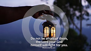 Bible verse quote - Do not afraid of them, the Lord your God himself will fight for you. Deuteronomy 3:22 on blurry background of